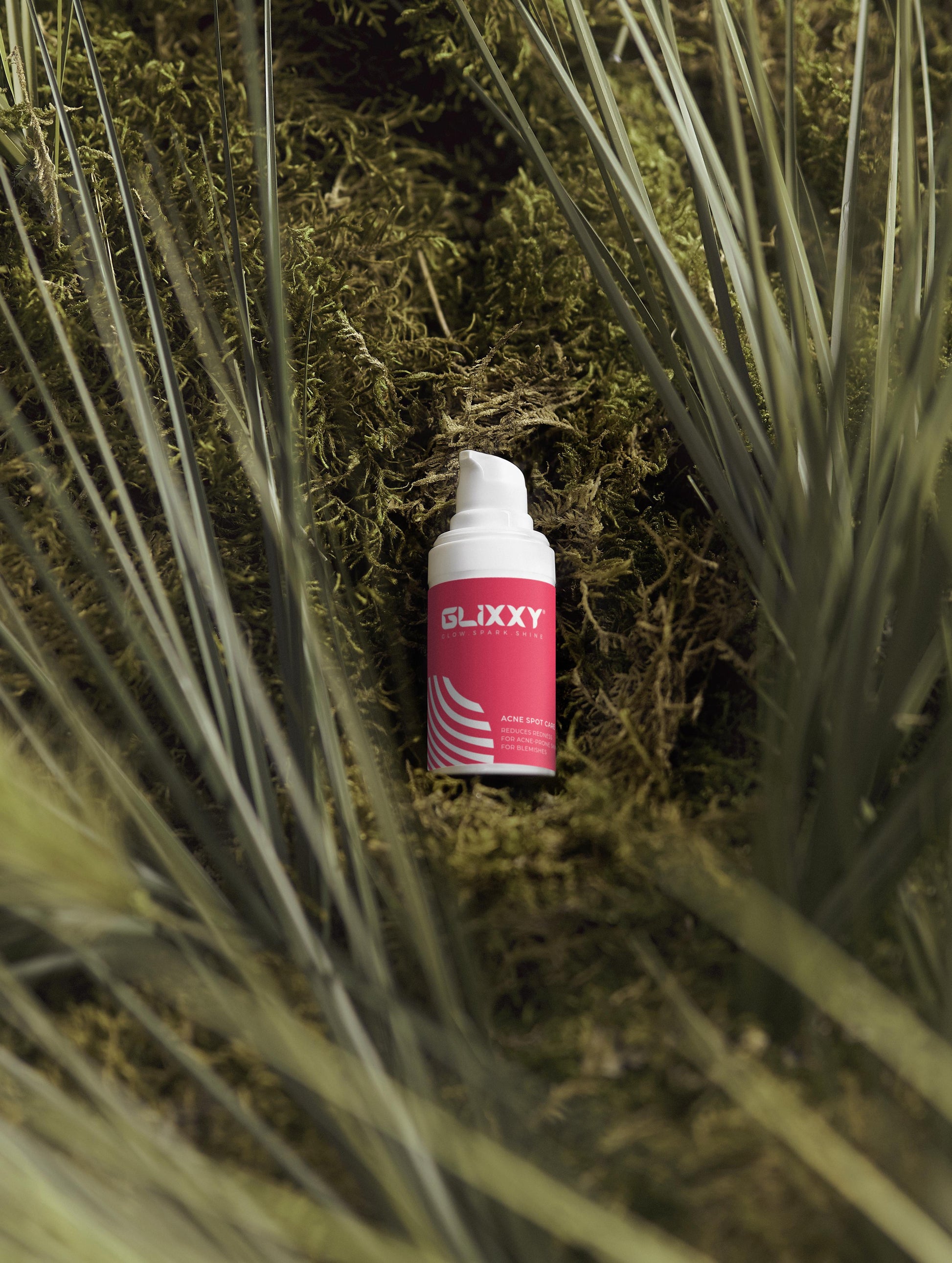 Glixxy cream bottle on a grassy background