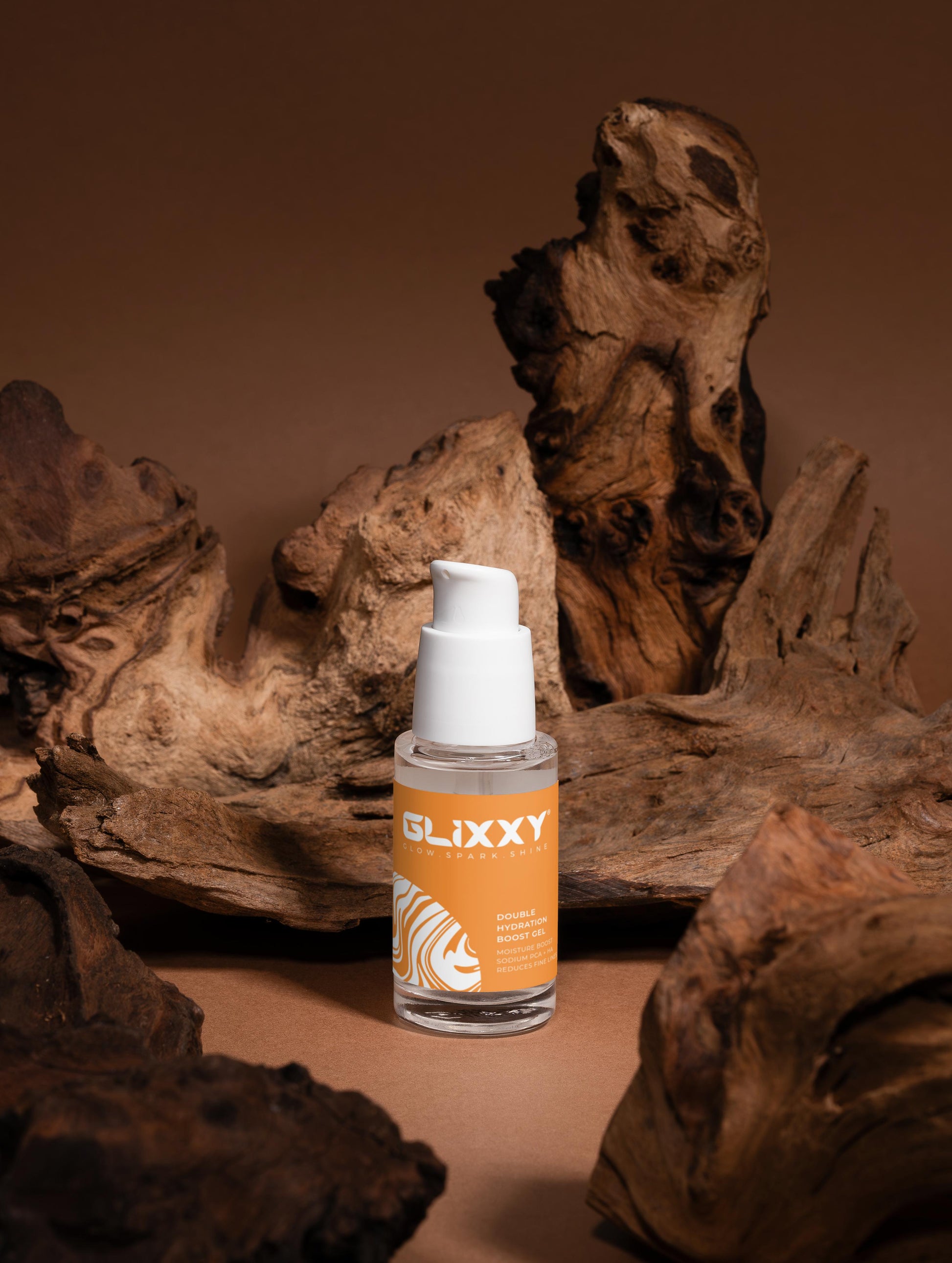 Glixxy bottle with an orange label on a brown background with wooden textures