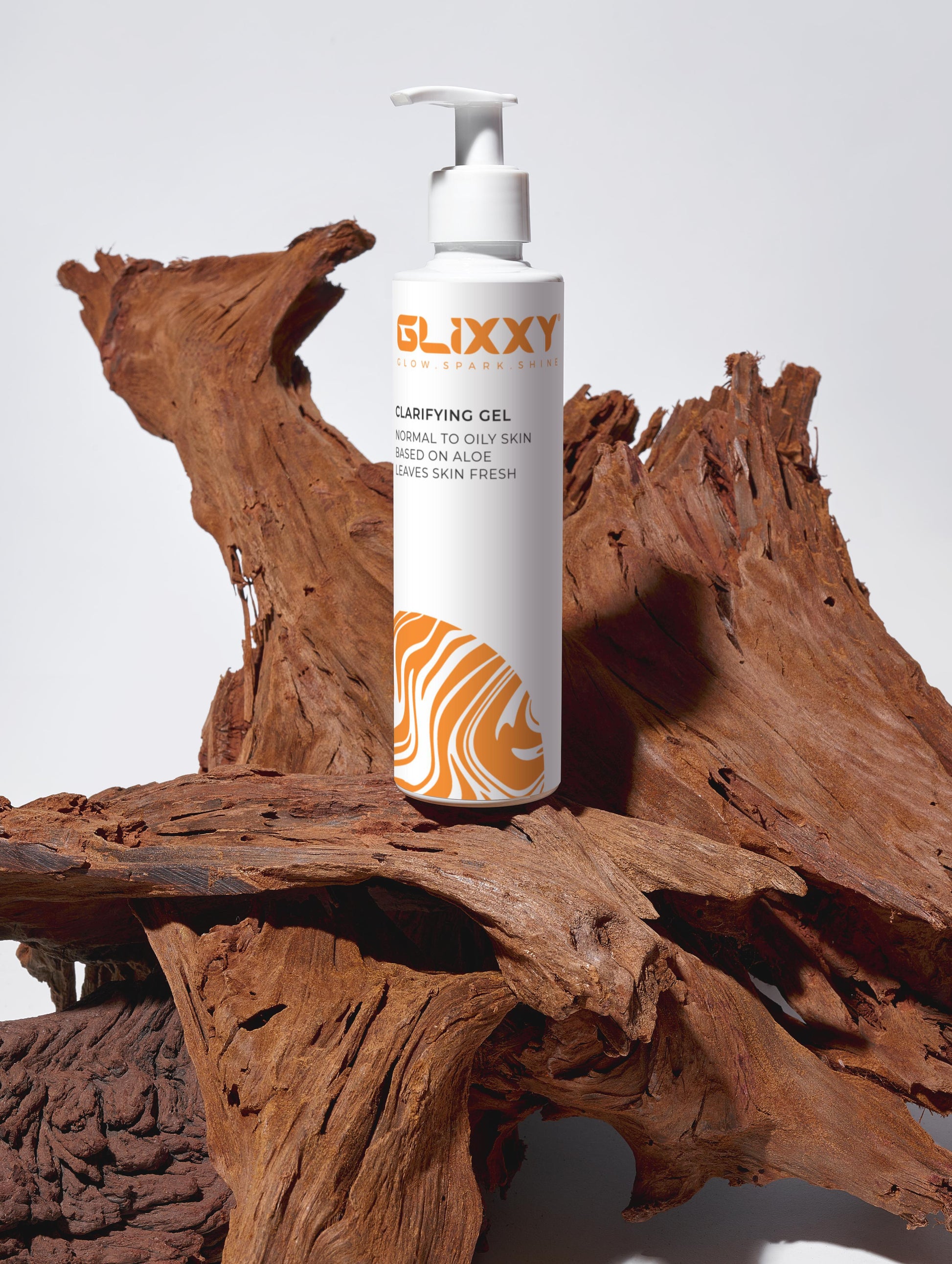 Glixxy clarifying gel bottle on a wooden surface