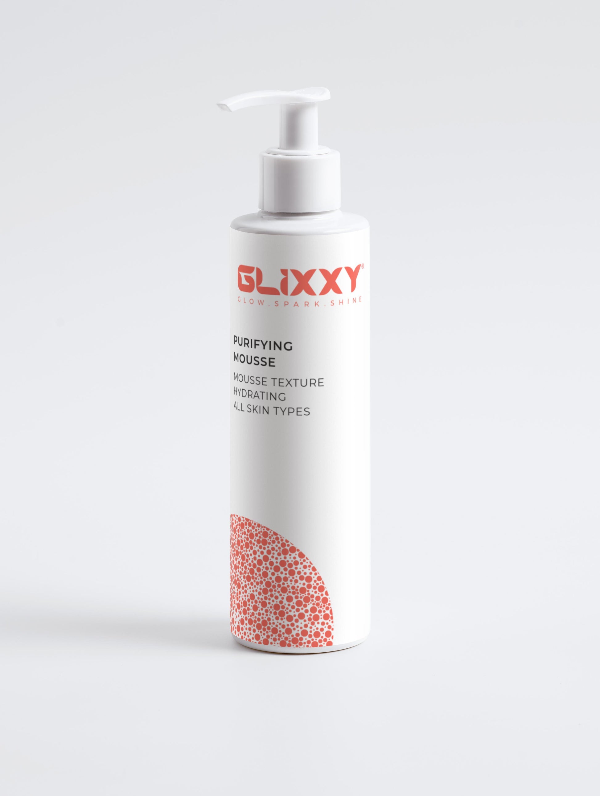 Glixxy purifying mousse bottle on a white background