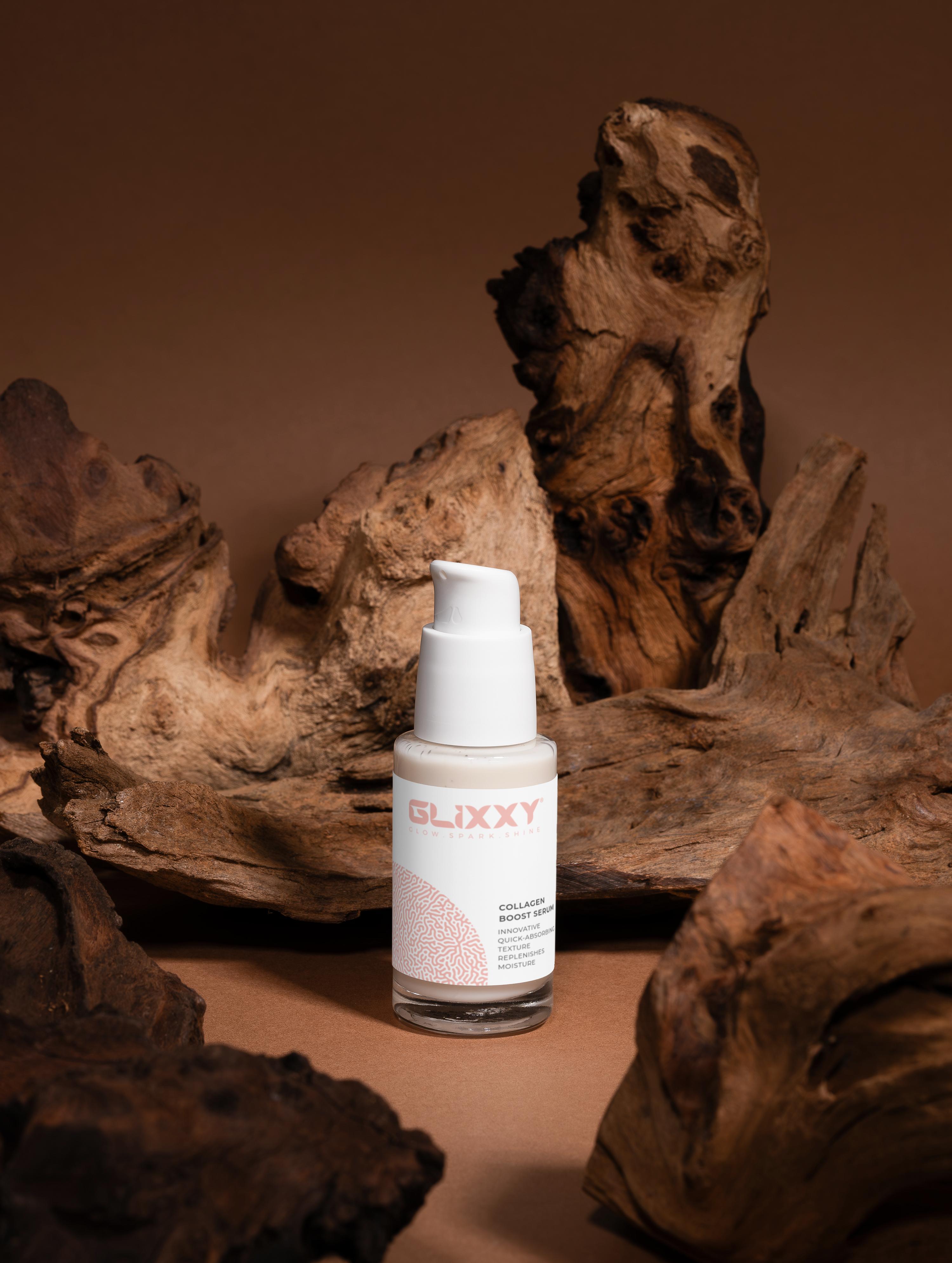 Skincare bottle labeled 'Glixxy' on a brown background with natural wood elements.