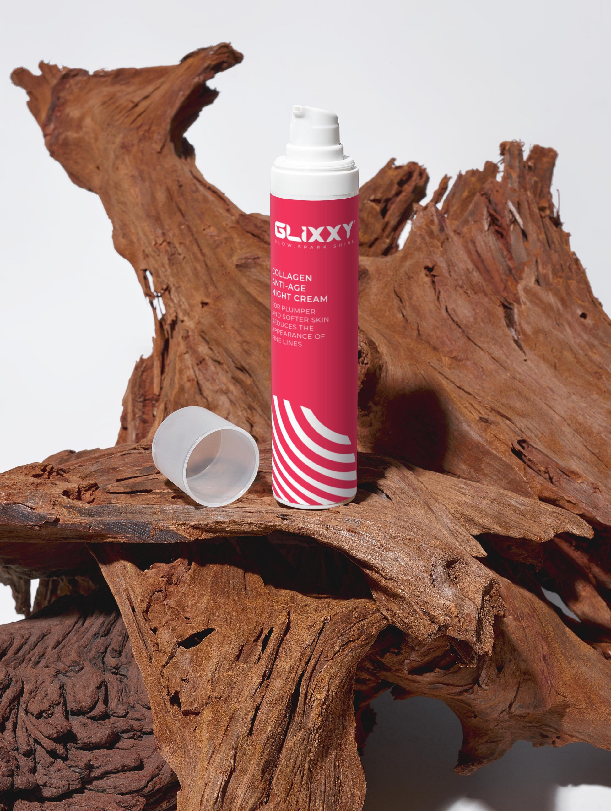 Glixxy collagen night cream bottle on a wooden surface