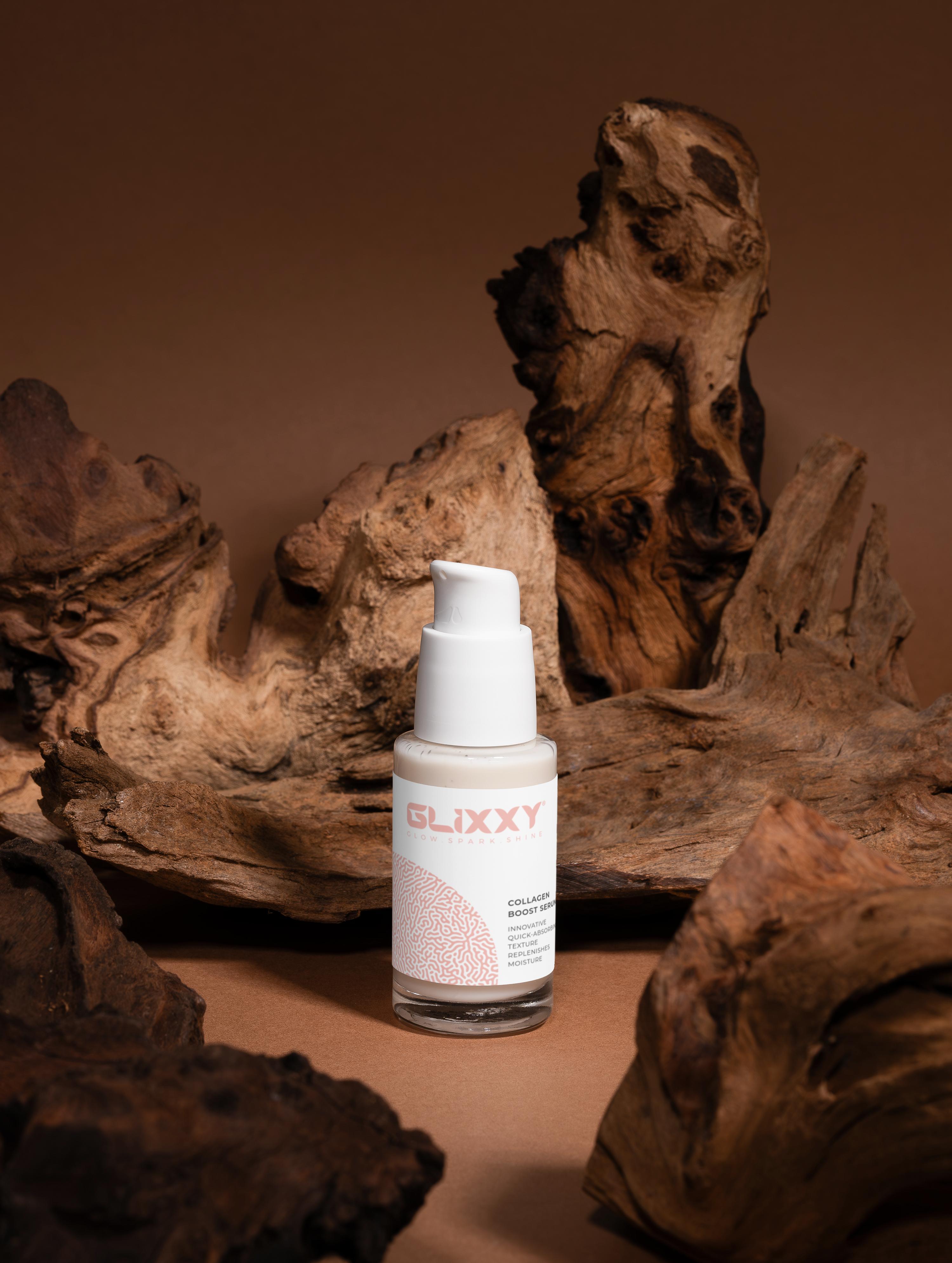 Skincare bottle labeled 'Glixxy' on a brown background with natural wood elements.