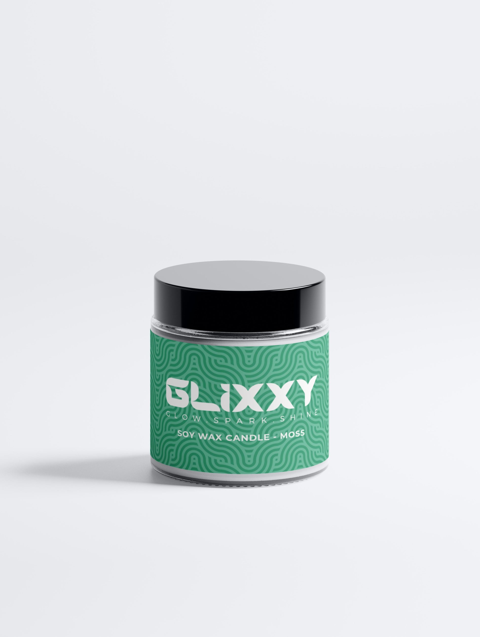 Glixxy soft wax candle in a green container on a white background