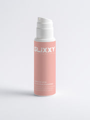 Pink skincare product bottle with white cap on a light gray background