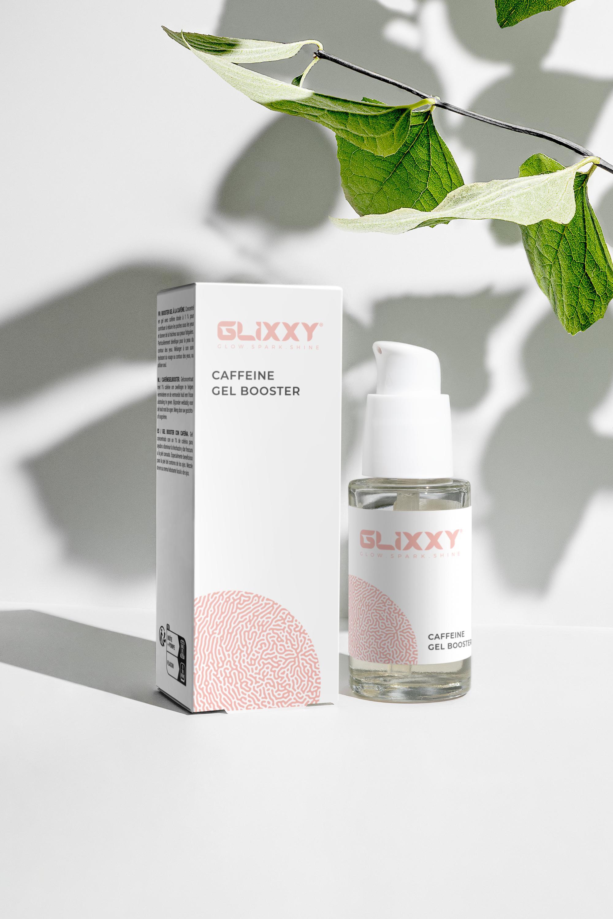 Glixxy caffeine gel booster packaging and bottle on a light background with leaves.
