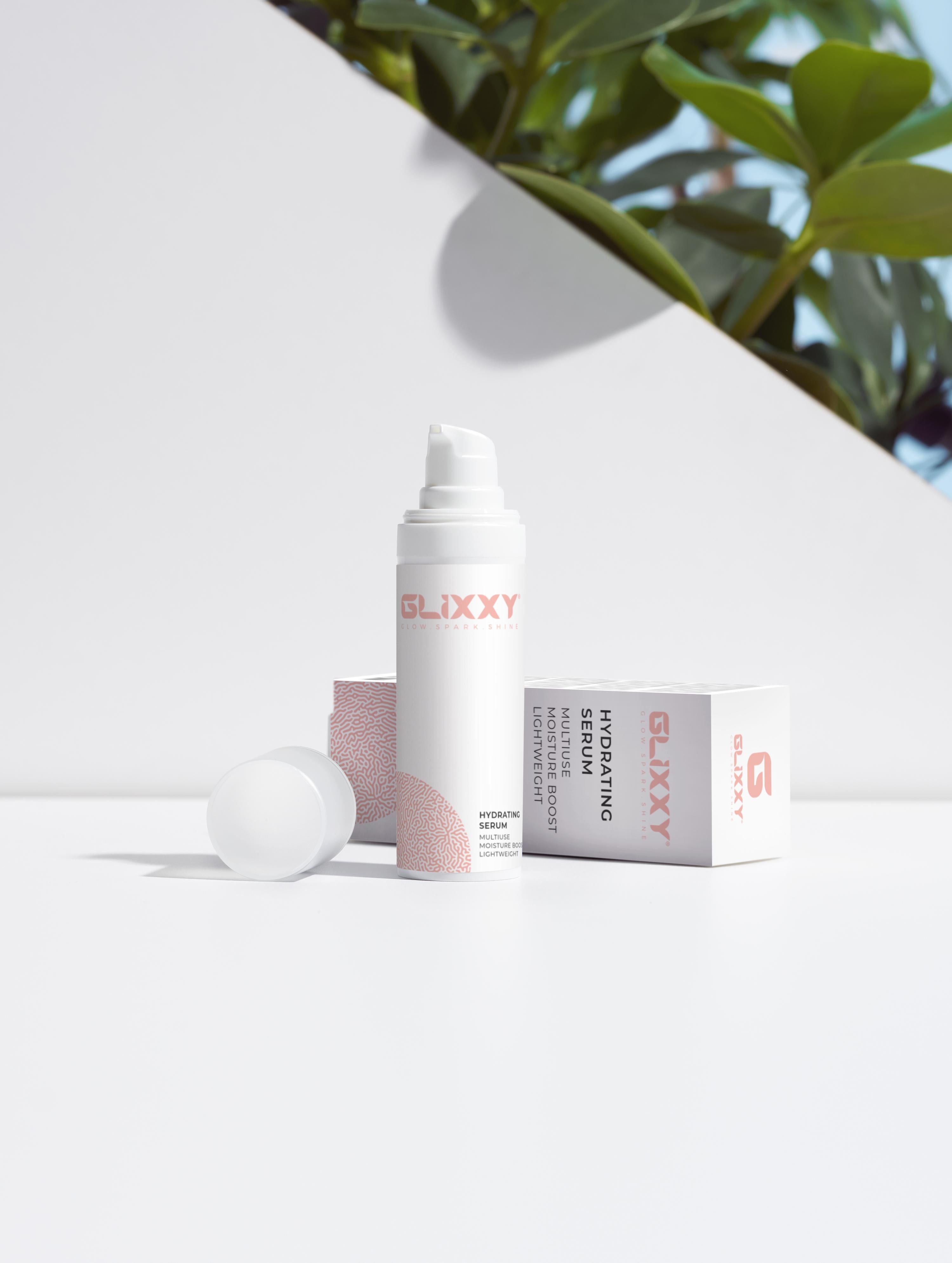 Glixxy skincare best hydrating serum product on a white surface with greenery in the background