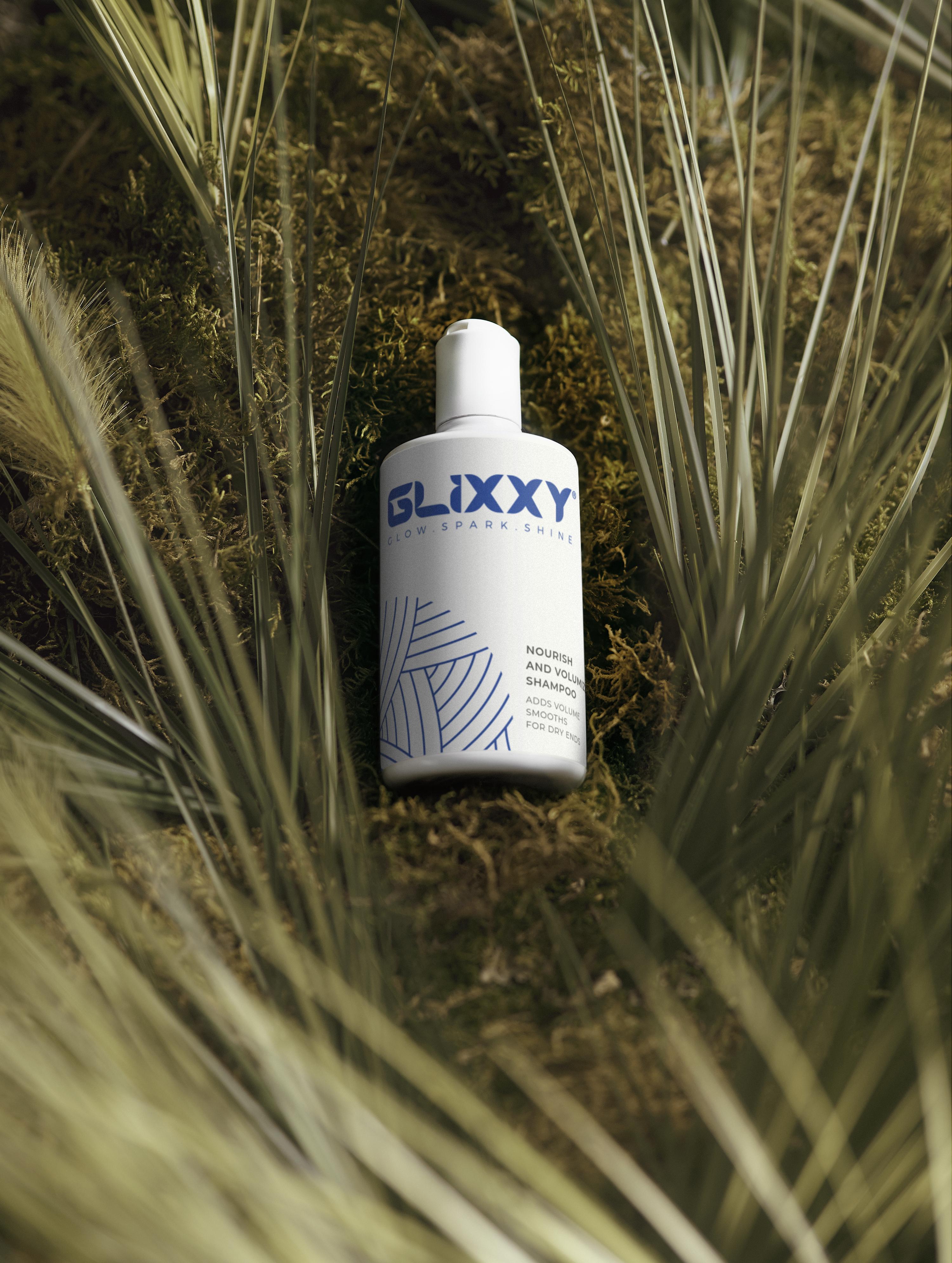 Glixxy best shampoo for volume​
bottle on a natural background with grass and moss