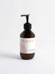 Glixxy body serum bottle with pump on a white background