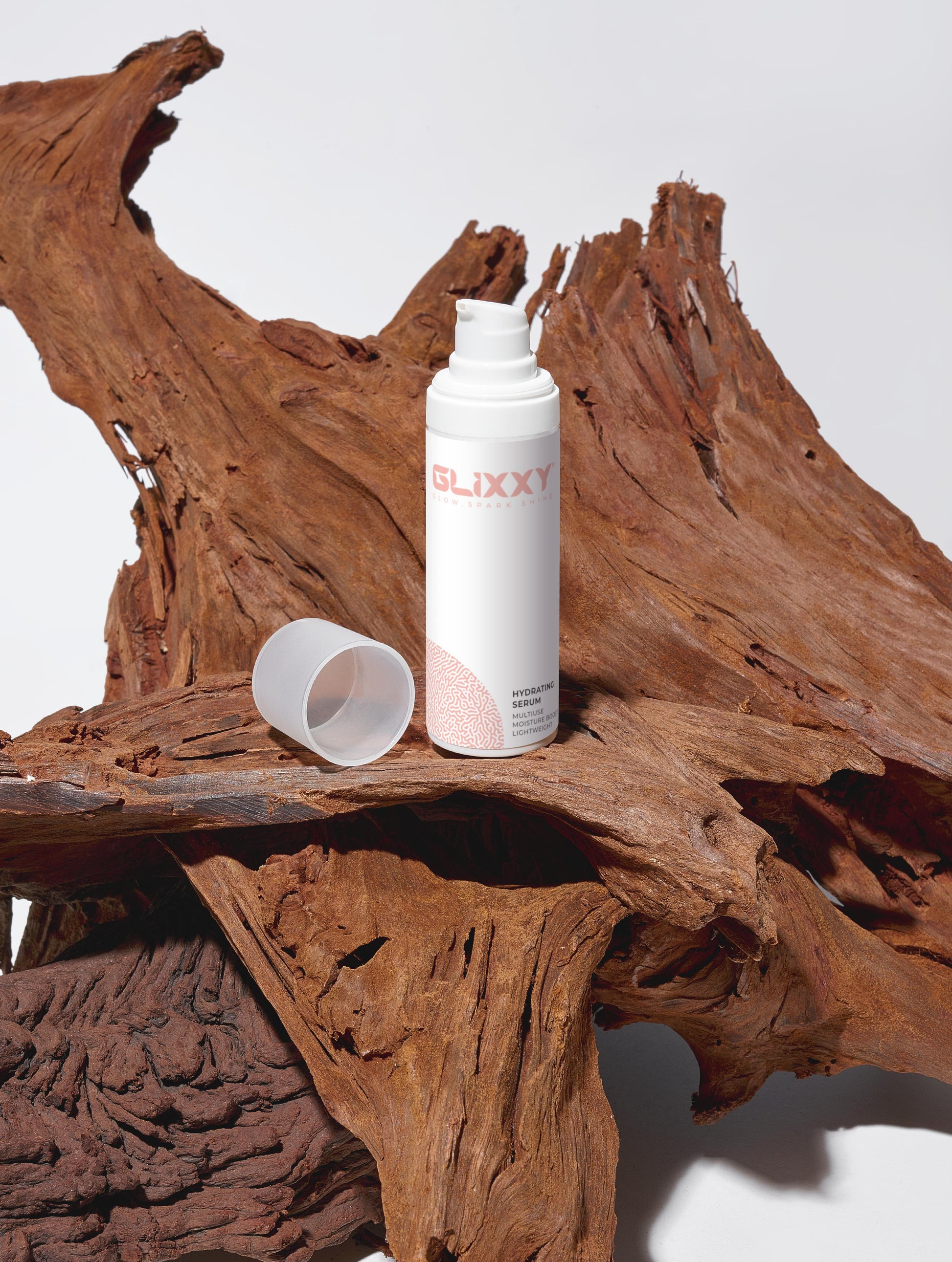 Glicky facial serum hydrating product bottle on a wooden surface with a white background
