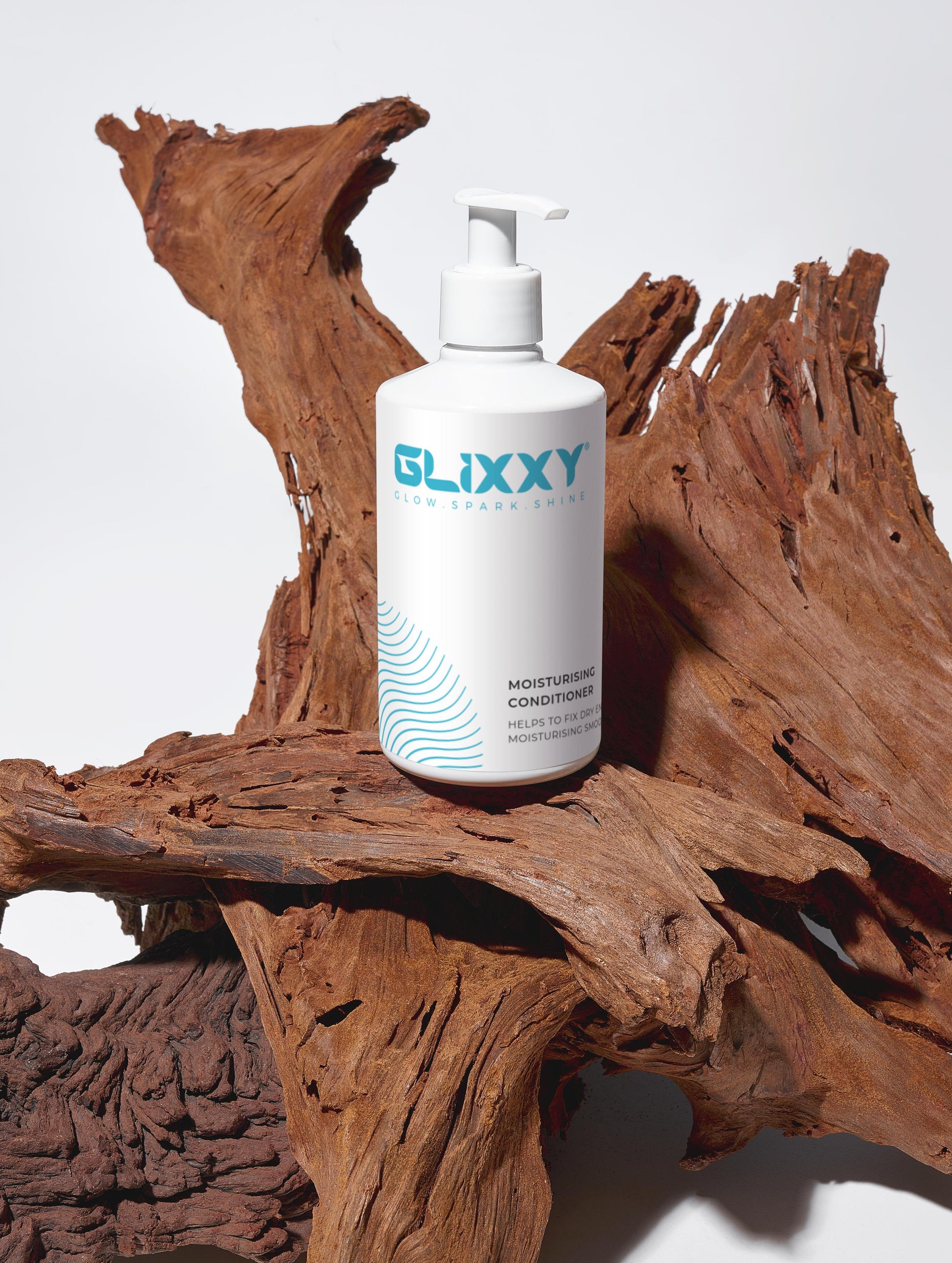 Glixxy skincare moisturising conditioner for dry scalp bottle on a wooden surface
