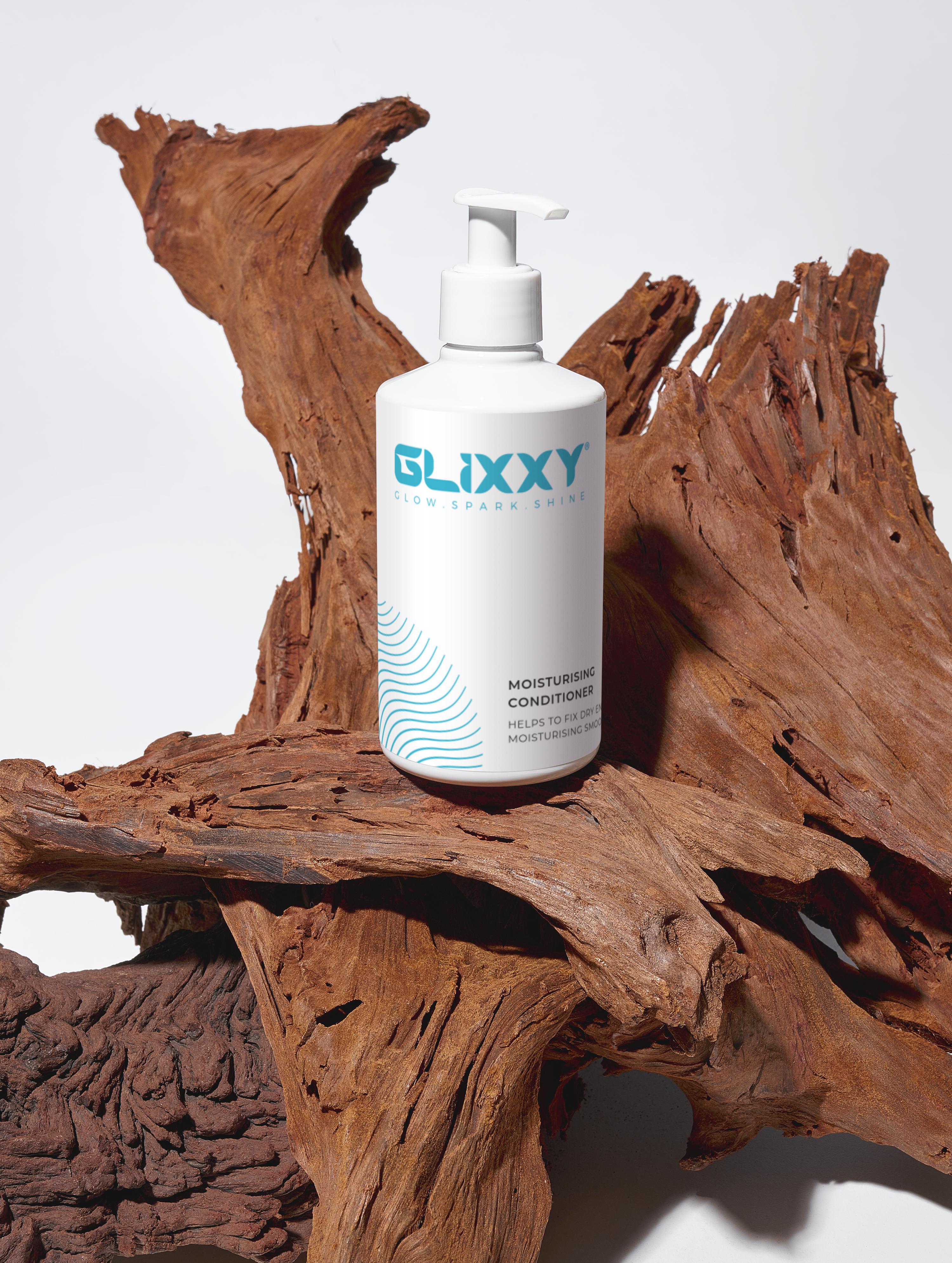 Glixxy skincare moisturising conditioner for dry scalp bottle on a wooden surface