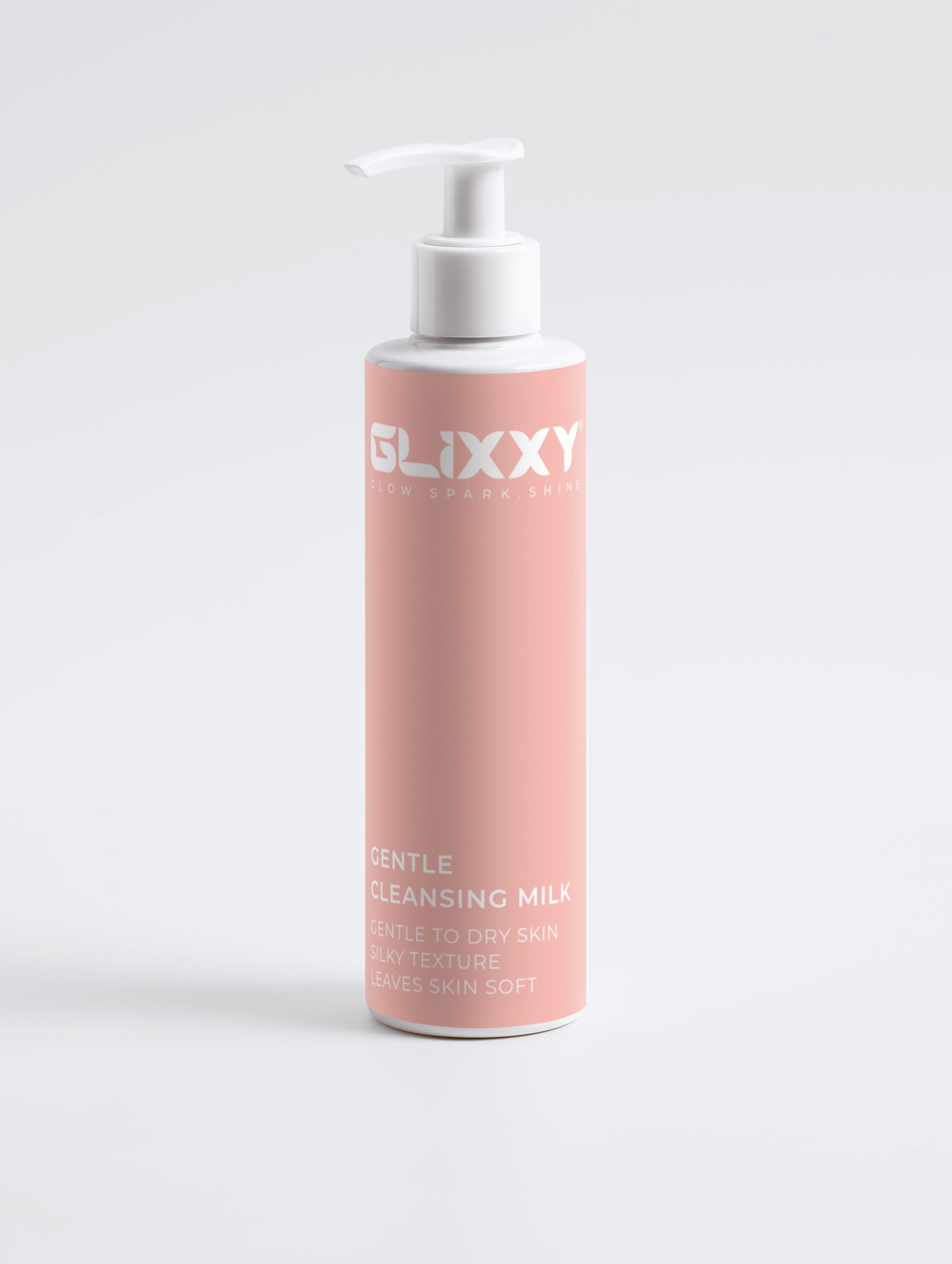 Pink bottle of Glixxy Gentle Cleansing Milk on a light gray background