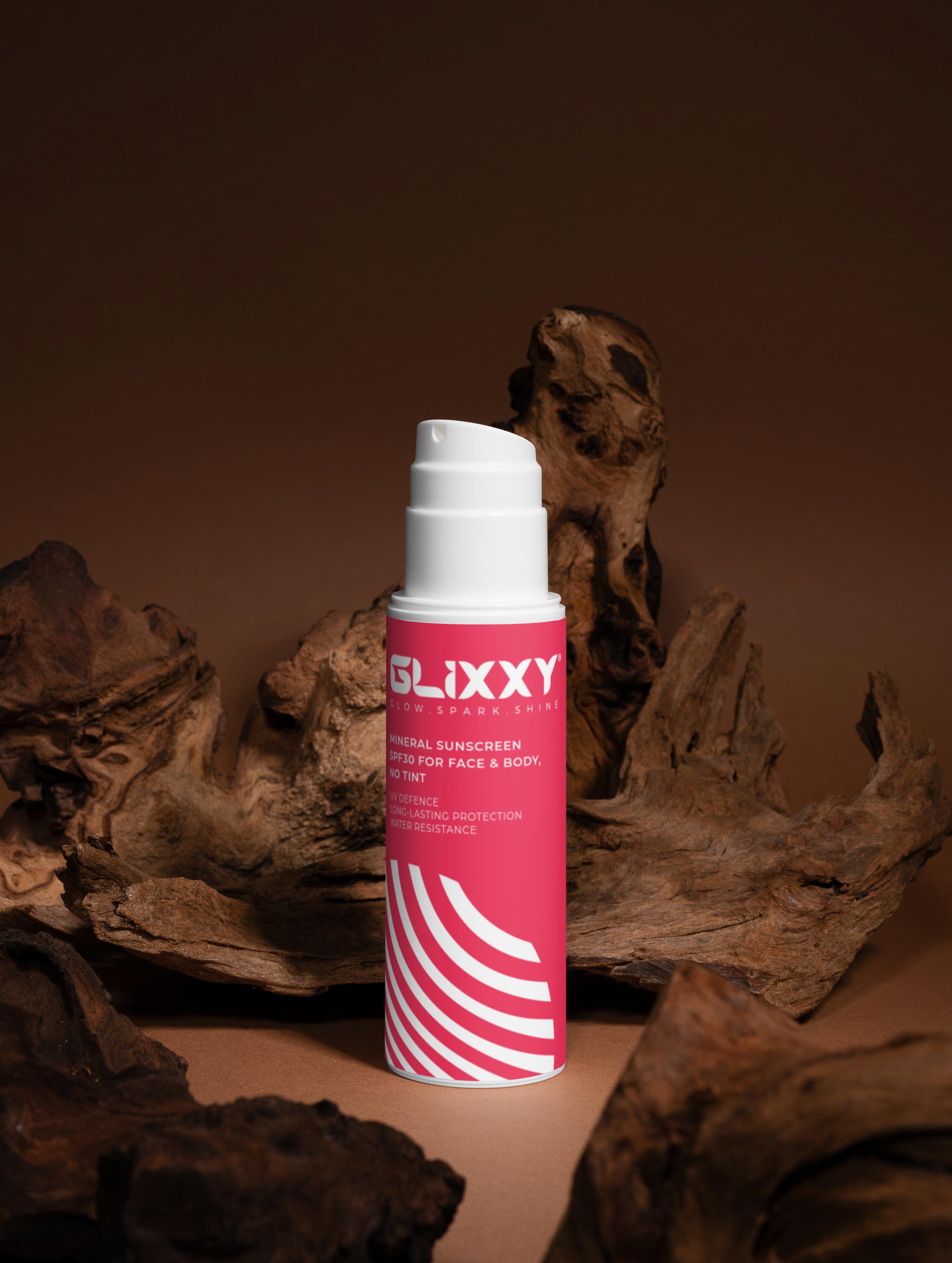 Glixxy sunscreen spf 30 for face and body can on a brown background with driftwood