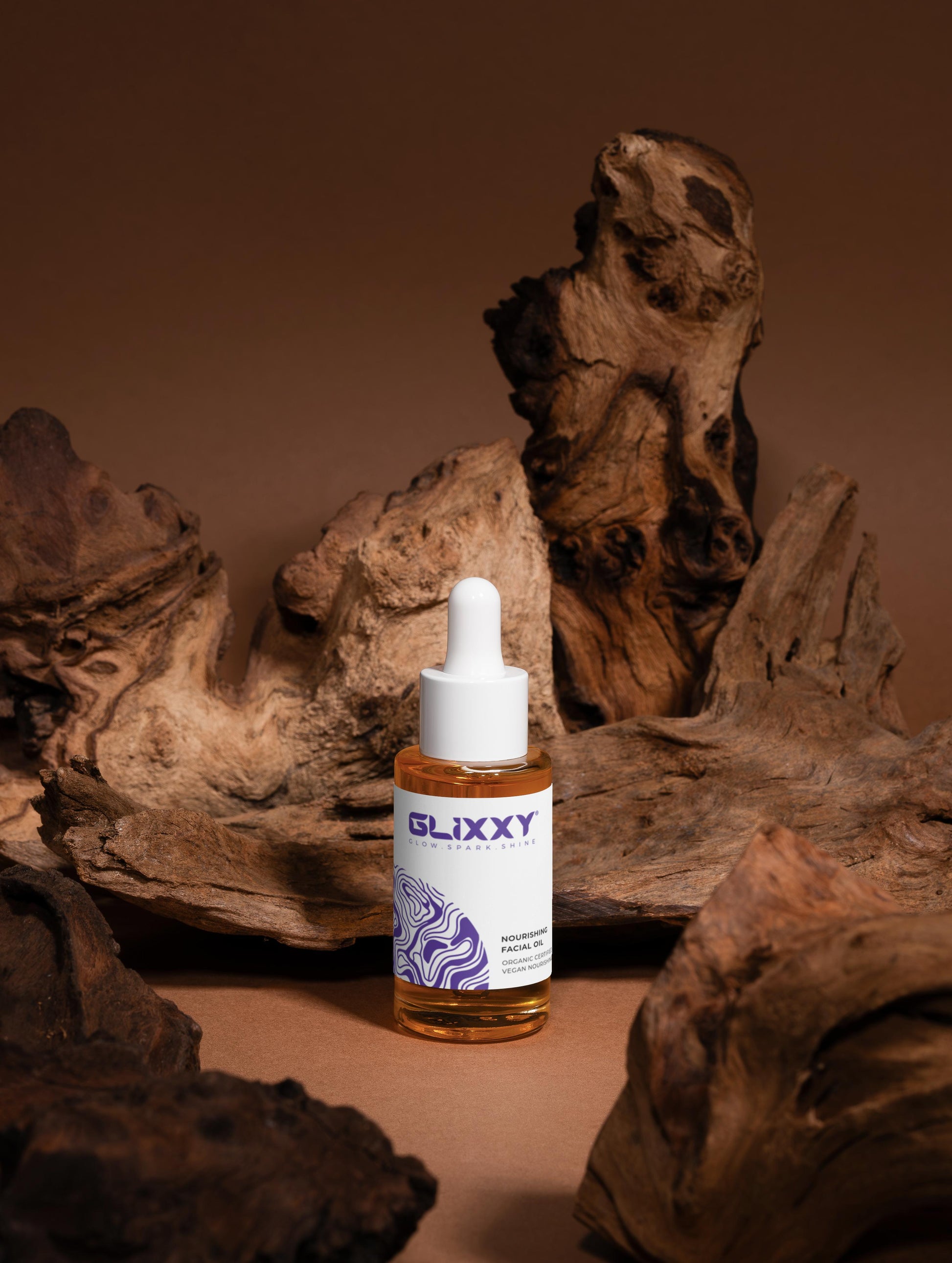 Glixxy bottle with dropper on a wooden surface